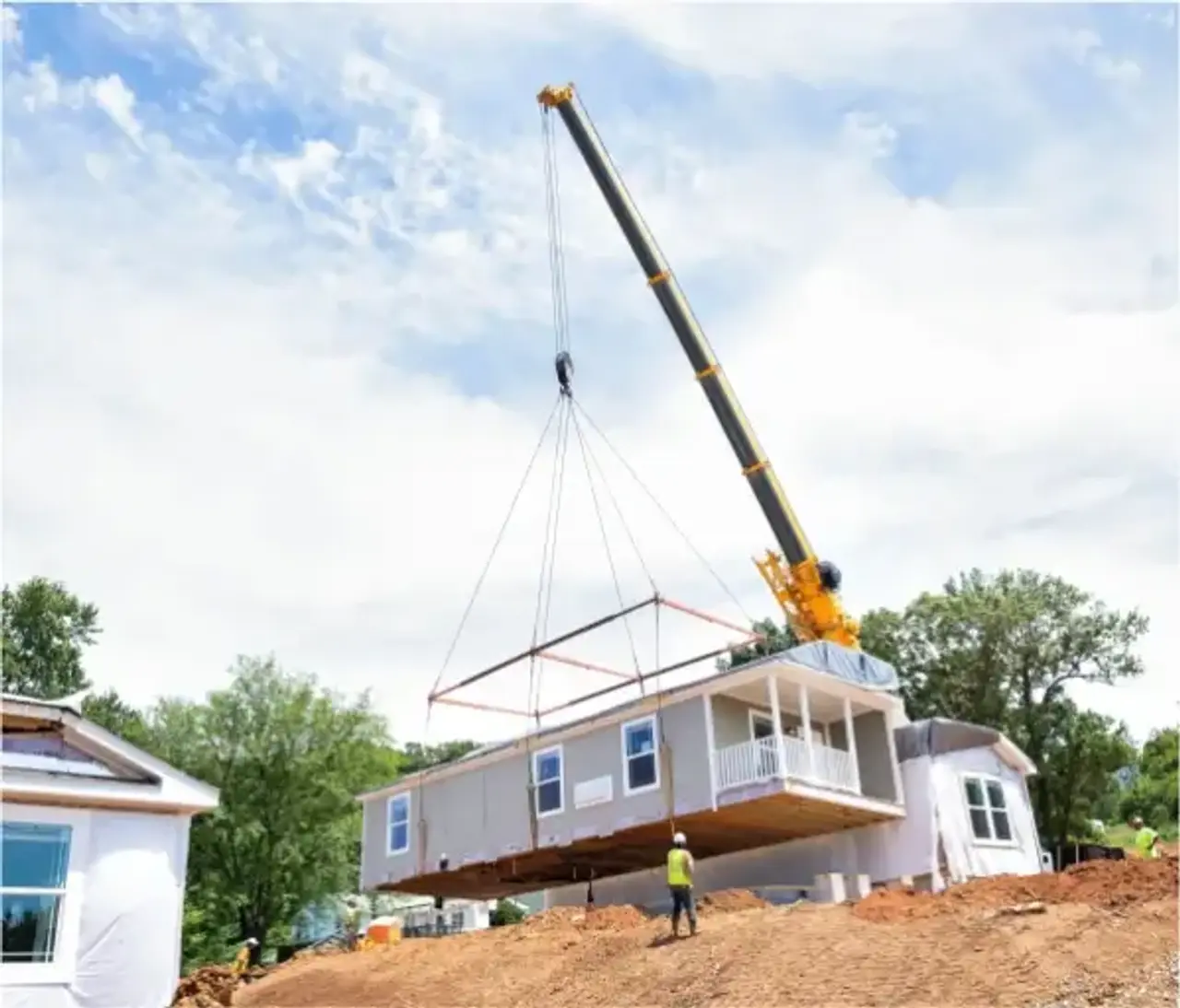 home being moved by a crane